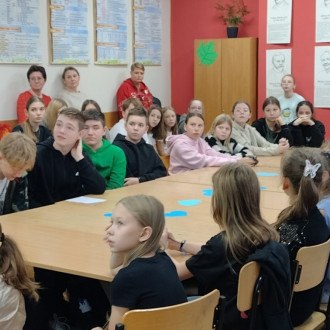 Uczniowie podczas debaty o prawach dziecka, w tle nauczyciele